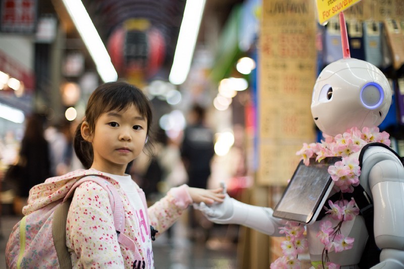 child interacting with a robot